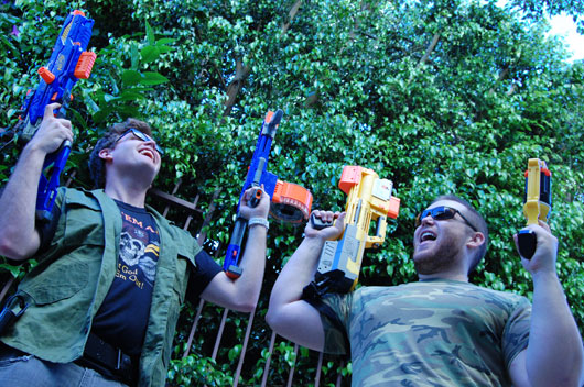 A group of people playing with nerf guns
