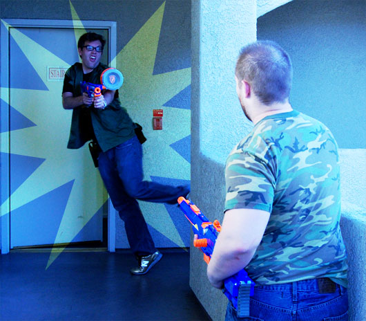 Two men playing with nerf guns