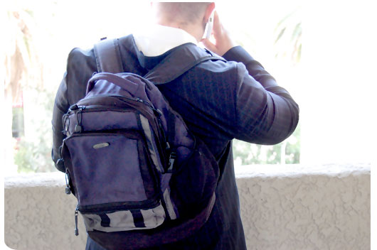 Suited man wearing a backpack