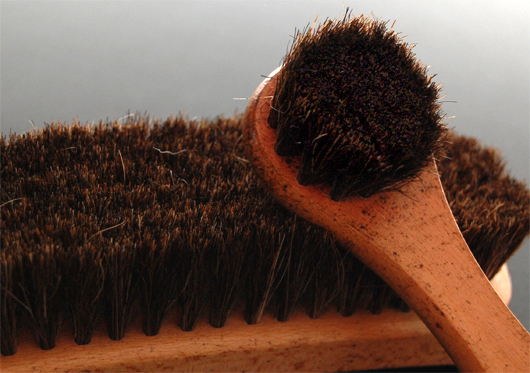 A close up of a shoe shine brush