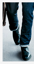 A man wearing cuffed jeans