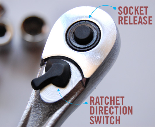 A close up of a socket release button and ratchet direction switch