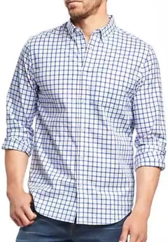 A person standing posing for the camera in a check shirt