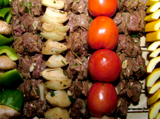 A pile of food, with Skewer and vegetables