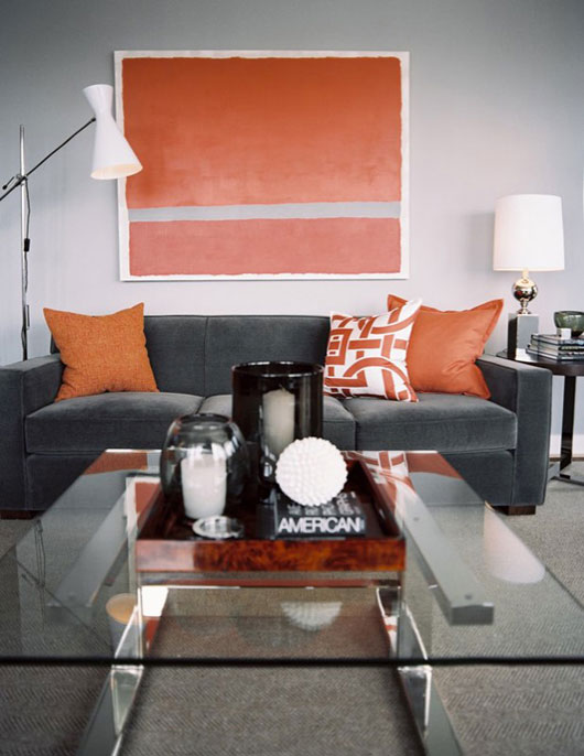 A living room filled with furniture and orange art