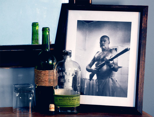 Ernest Hemingway photo in frame with bottles