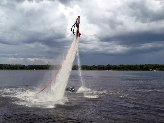 A man flying through the air over a body of water