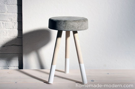 A close up of a cement stool