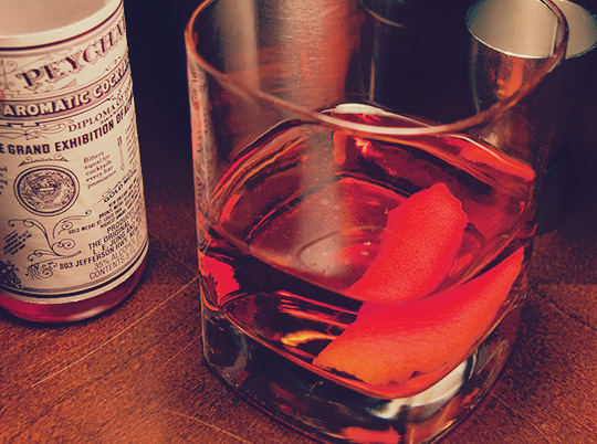 A sazerac cocktail in front of ingredients