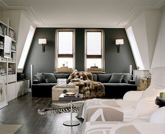 A uniquely shaped room with gray wall