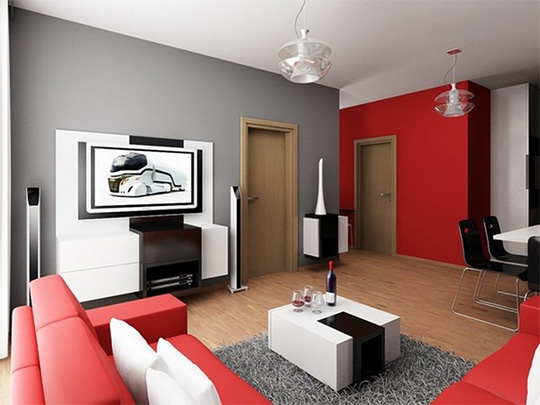 A living room filled with furniture with a red wall