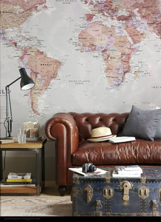 Brown leather couch with giant map on wall