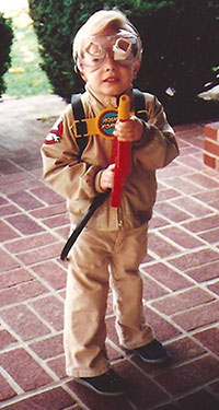 A small boy dressed in a Ghostbusters costume