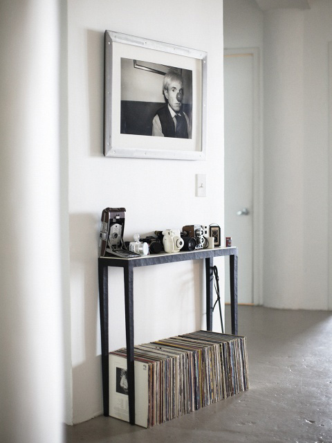 A record shelf with a photo of Andy Warhol