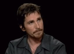 Christian Bale looking at Kermit and nodding