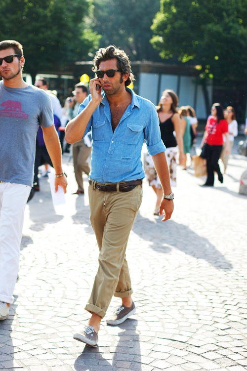 a man wearing a blue denim shirt with khakis