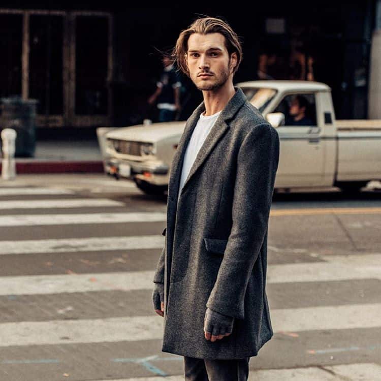A person wearing a long coat on the street