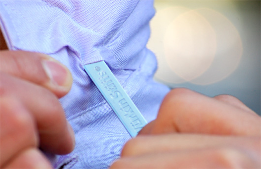 A close up of a hand putting in wurkin stiff collar stay