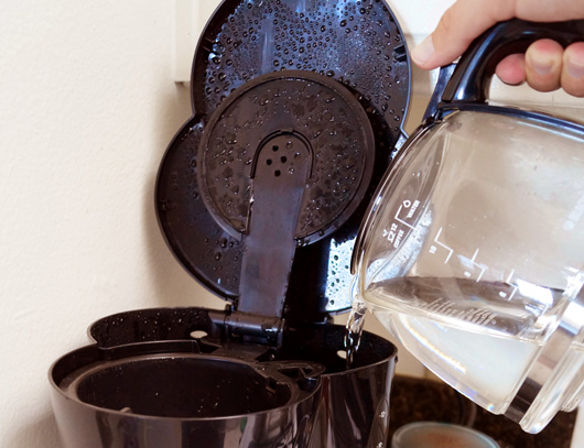 Pouring water into coffeemaker