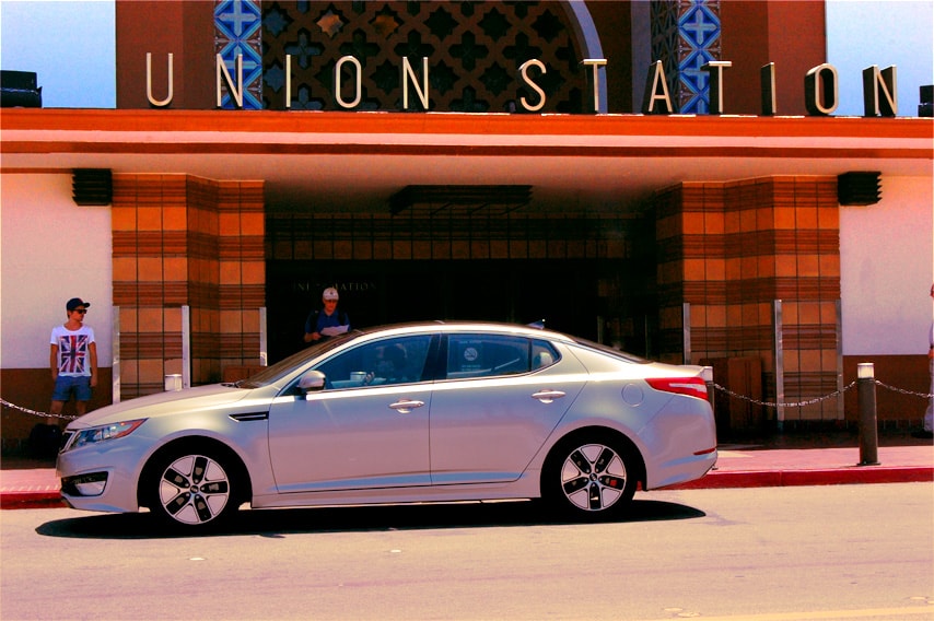 kia optima vehicle parked in front of a building entrance