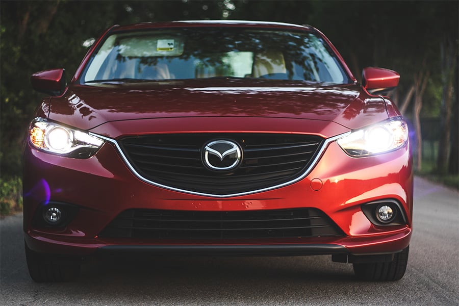 front headlight and grill view of mazda 6 i touring vehicle