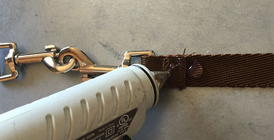 Hot glueing dog leash for DIY Ghostbuster costume