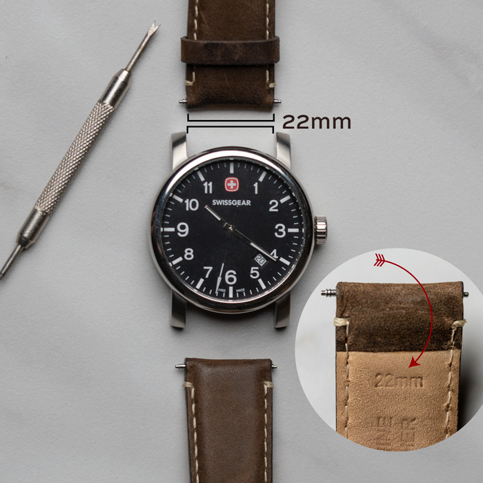 a 22mm watch band measurement with watch repair tools and a swiss gear brand watch dial