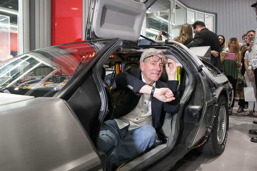actor Bob Gale as Marty sitting inside Delorean car from Back to The Future