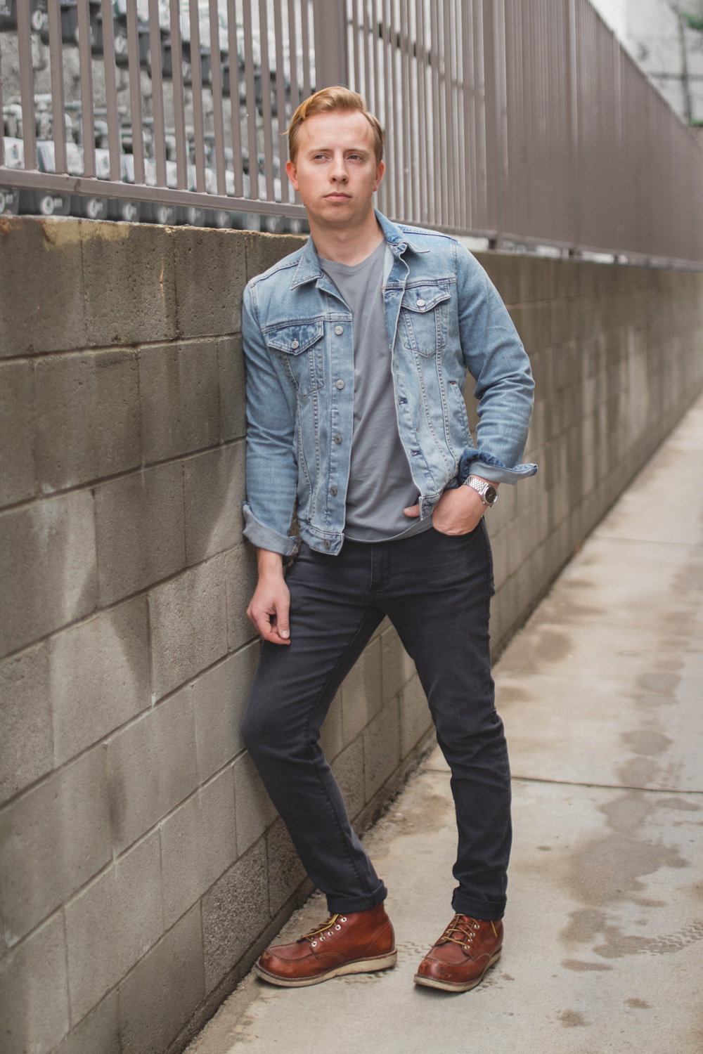 light blue denim jacket with gray jeans and red wings