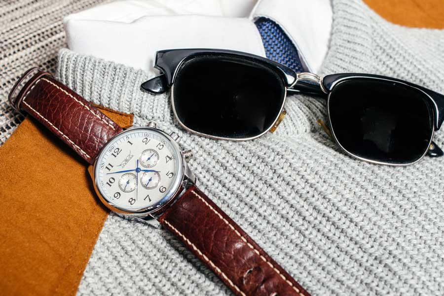 close up of sunglasses and watch