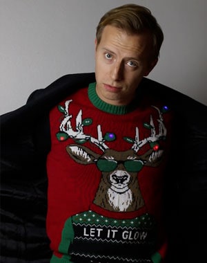 Man wearing Let It Glow Ugly Christmas Sweater
