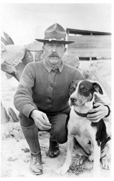 A man and a dog posing for the camera
