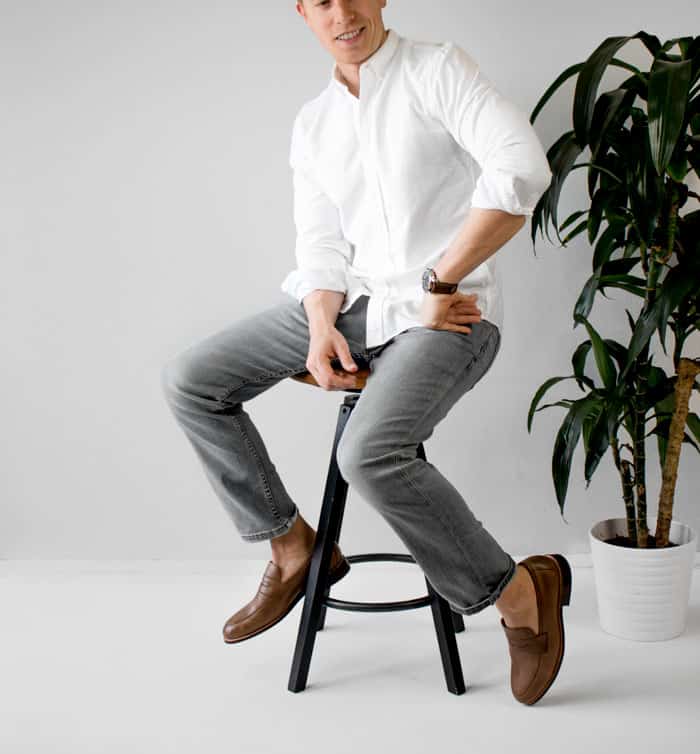 man wearing white shirt with grey pants and leather loafers