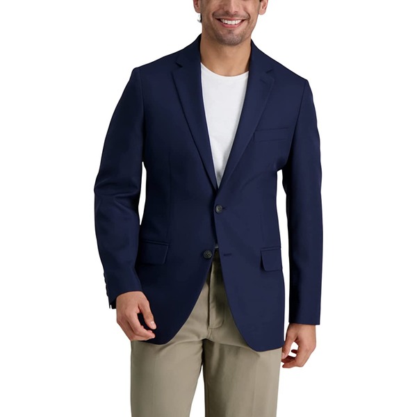 a man wearing a navy blazer over a white shirt