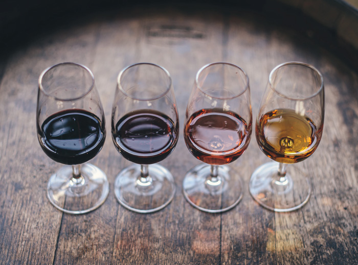 wine glasses with different types of wine ranging in color from red to white