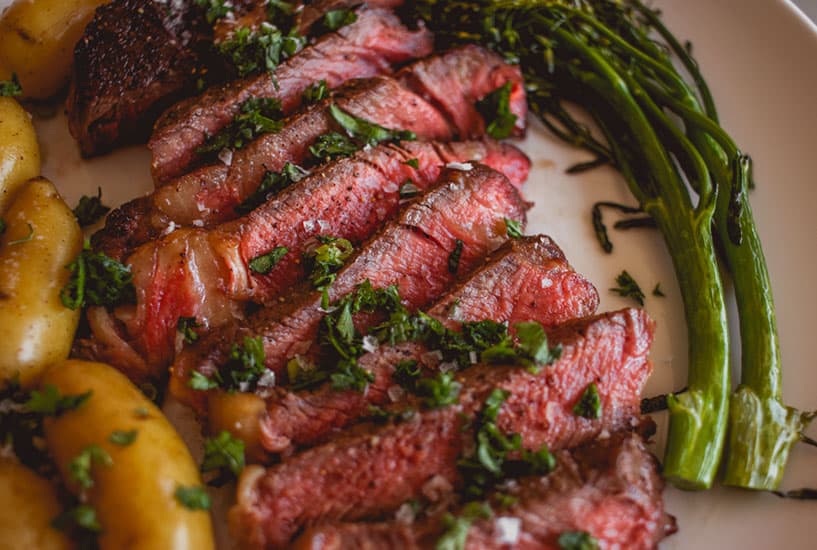 a plate of steak and roasted vegetables