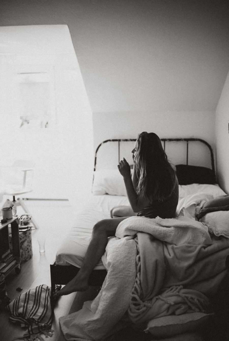 Image of woman sitting on a bed