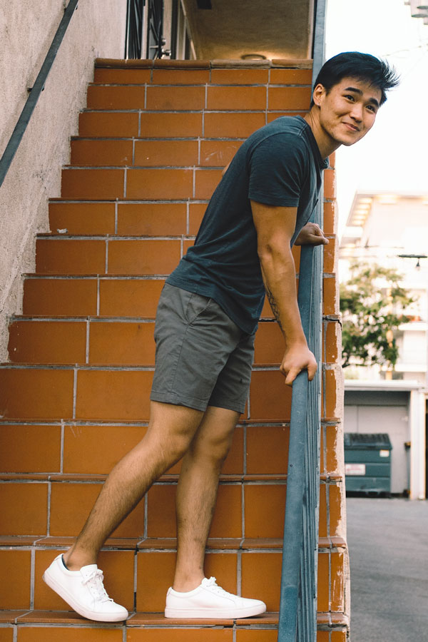 black tshirt brown shorts white sneakers