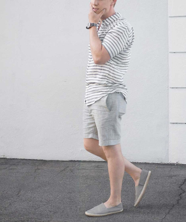 man wearing a grey striped shirt, linen shorts, and espadrilles