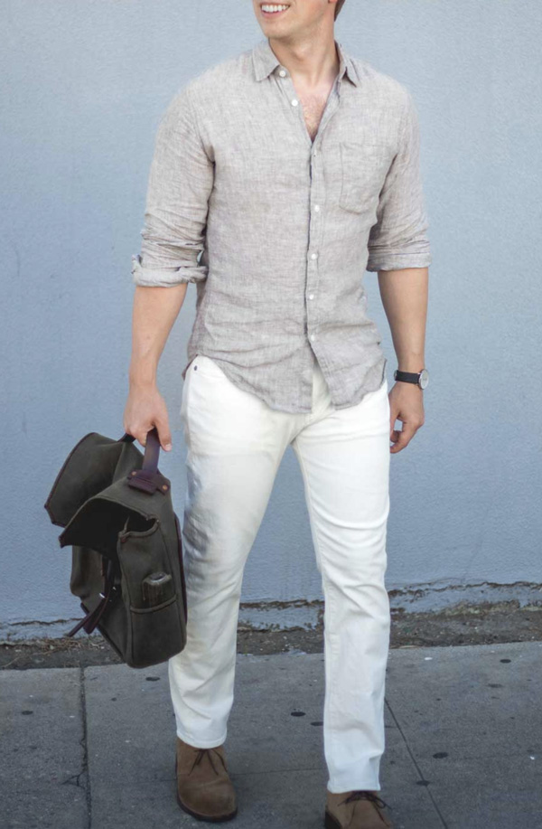 man wearing a linen button up shirt, slim fit pants, casual shoes, and carrying a briefcase bag