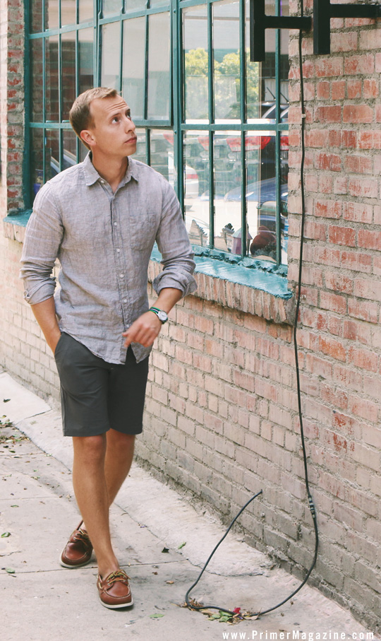 a man wearing a linen shirt, shorts, and boat shoes