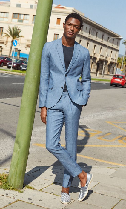 man wearing a linen suit with a shirt and espadrille shoes