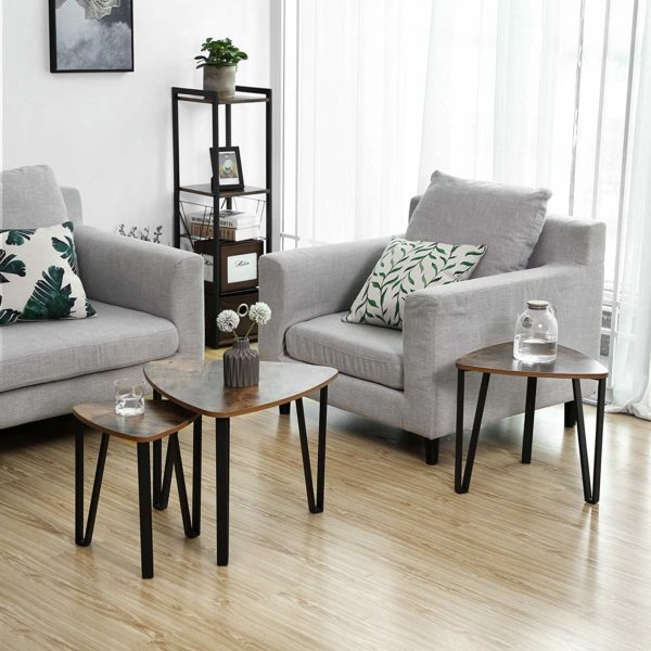 a space saving nesting coffee table in a living room with chairs and a decorative shelf