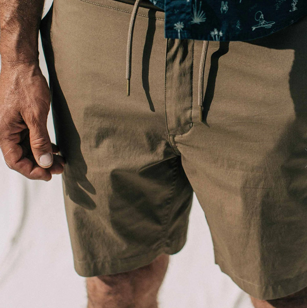 A man wearing taylor stitch drawstring shorts