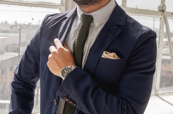 man wearing a button down collar shirt with tie and blazer