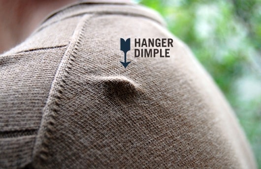 close up of a hanger indent on the shoulder of a sweater