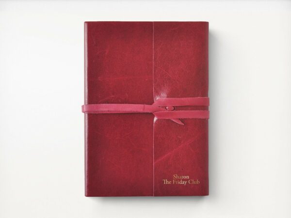 image of a red leather notebook with a wrap