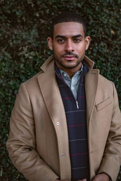 man wearing a winter coat and a half zip sweater for primer magazine