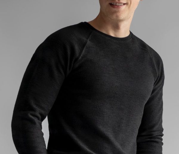 close up of a man wearing a black thermal style sweater for primer magazine