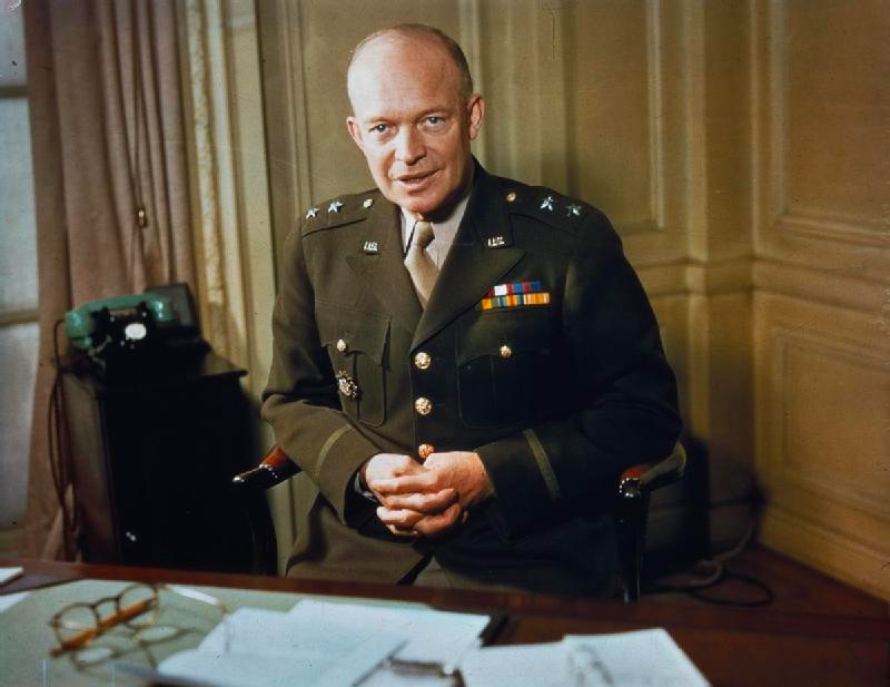 Eisenhower standing in front of desk